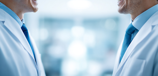 Twin White Male Medical Doctors Looking at Each Other