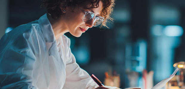 Older, Female Medical Doctor Writing a Prescription