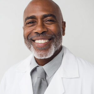 Jamaican-American Medical Doctor Smiling Needing Credentialing