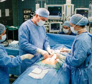 Abdominal surgery scene, multiple surgeons.