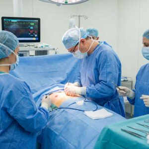 Breast surgery scene, with multiple surgeons