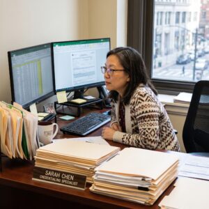 Medical Credentialing Specialist Analyzing Data at Desk