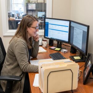 Medical Credentialing Specialist Analyzing Data at Desk
