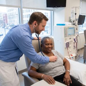 Nephrologist Assisting an Elderly Patient