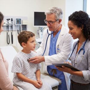 Two Doctors Treating a Pre-teen Patient