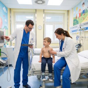 Two Doctors Treating a Young Boy Patient